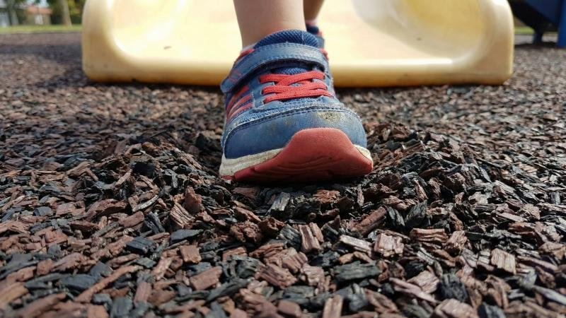 Child Foot Stepping On Rubber Mulch Playground Surfacing