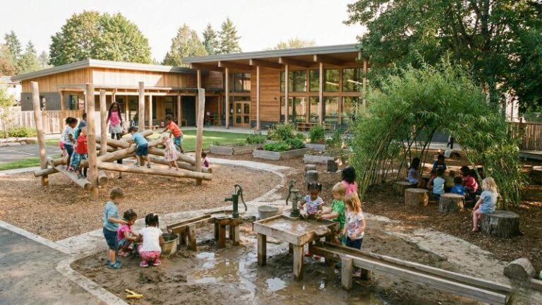 Preschool children playing on a nature based outdoor playground