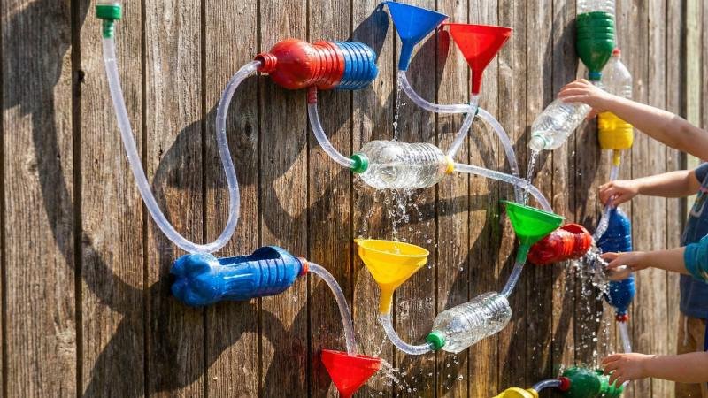 DIY Water Wall With Funnels On Wooden Fence