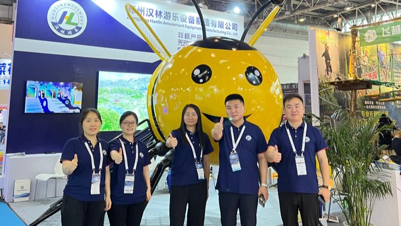 Hanlin Amusement team at Beijing Expo 2023 booth with custom bee playground