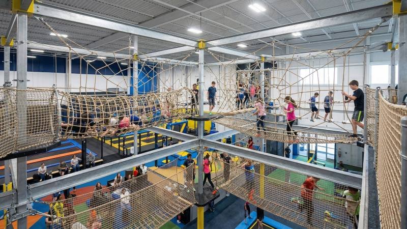 Massive multi-level suspended rope net maze inside family entertainment center