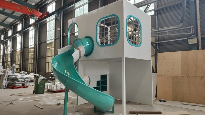 Full View Of Custom White And Teal Indoor Playhouse With Slide