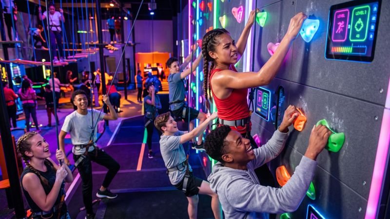 Teenagers Playing on Interactive Climbing Wall