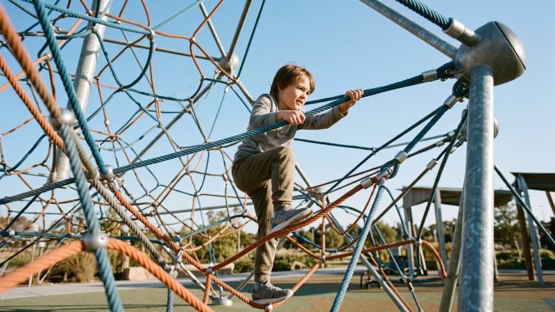 Children Climbing Complex Rope Net Structure